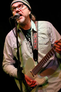 Greg Koch (lead vocals, guitars, backing vocals)